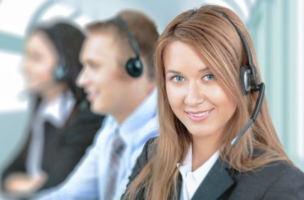 Service. Closeup of a call center employee with headset at workplace